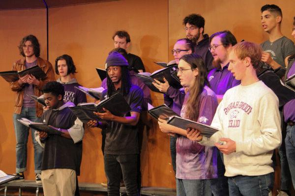 a group of people singing on stage